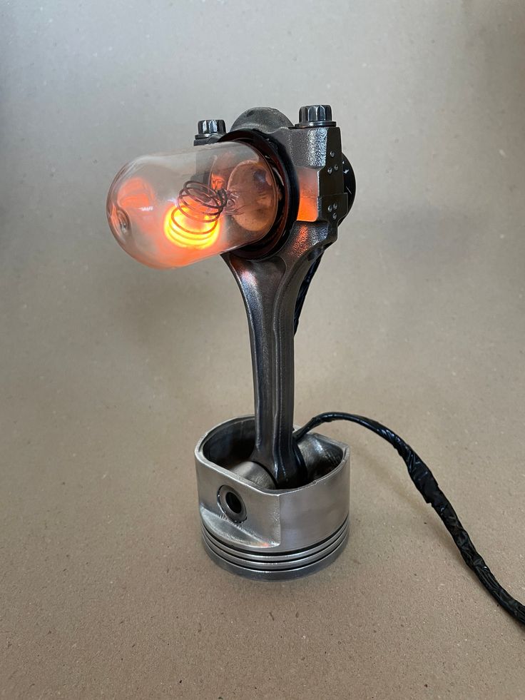 a light that is sitting on top of a metal object with a cord attached to it