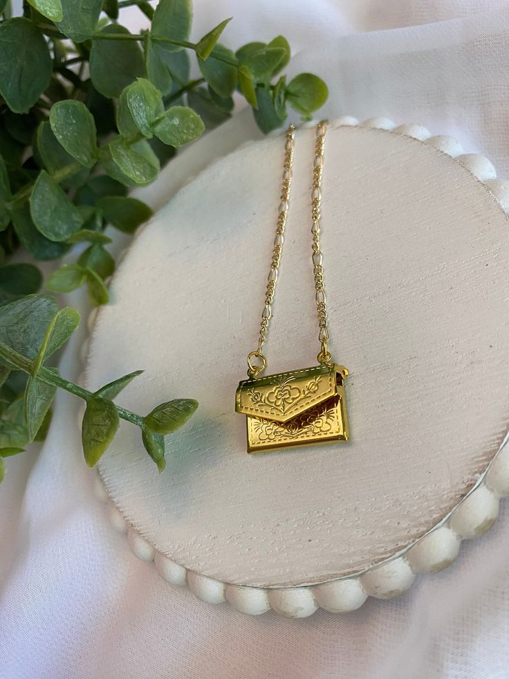 This necklace is made with a 16in. gold colored chain, and gold colored envelope charm. The envelope charm opens and you could put a small note in it.  This necklace would be perfect for a Valentine's Day gift!  If you have any questions contact owner and designer at HannahsJeweltique@gmail.com  Visit my website at HannahsJeweltique.com Gold Locket Necklace For Birthday Gift, Gold Rectangular Jewelry For Best Friend Gift, Gold Rectangular Keepsake Necklace, Gold Rectangular Necklace For Keepsakes, Rectangular Gold Jewelry For Best Friend, Gold Personalized Envelope-shaped Necklace, Gold Rectangular Necklace For Best Friend, Gold Rectangular Locket Necklace For Gifting, Gold Rectangular Locket Necklace For Gift