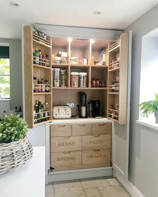 a kitchen with lots of wooden cabinets and drawers