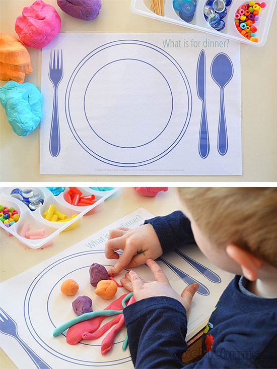 a child is playing with play dough and plastic spoons in front of a paper plate