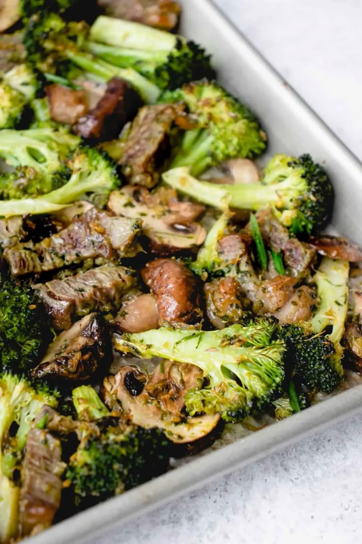 broccoli and mushrooms in a pan on a table