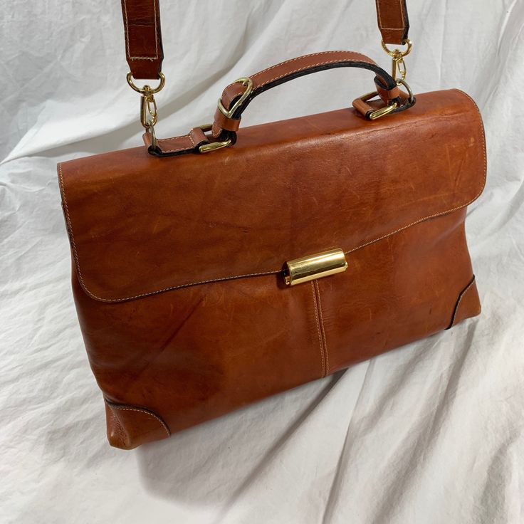 Measurements are 14"2  bottom wide, 9" high, 4" deep with a 48" shoulder strap with a 24" drop.  On the interior there are two main compartments, lined in fabric, back zipper pocket and a front top closure. Bag is made of strong leather with light stitching, silver tone hardware, top handle and the shoulder strap is detachable.   There are a few scuffs and some marks with no tears and bag is as pictured. Nice leather bag and is perfect for work, school, travel, daily use and looks great. 100% genuine leather.  ----------------------------------------------------I SHIP WORLDWIDE------------------------------------------------- I want to stress that item is vintage which means it's not new. All my customers are very important to me and I believe communication is very important. I do not sell Classic Double Flap Bag, Travel Bags In Soft Leather With Double Flap, Travel Bags With Soft Leather And Double Flap, Classic Shoulder Flap Bag With Adjustable Strap, Classic Double Flap Travel Bag, Classic Double Flap Business Bag, Formal Bags With Double Flap And Leather Lining, Classic Satchel Shoulder Bag With Adjustable Strap, Vintage Double Flap Shoulder Bag For Formal Occasions