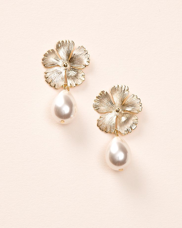 Bring a soft, feminine touch to your wedding day look with our Hayden Pearl Earrings. Each detailed metal flower is accented with an off white pearl drop that dangles effortlessly. Off white pearls Measures 1" x 1.5" long Hypoallergenic, lead-free & nickel-free Style #4456 Pearl Drop Flower-shaped Bridal Earrings, Delicate Pearl Charm Flower Earrings For Wedding, Formal Pearl White Flower Drop Earrings, Feminine Metal Jewelry For Wedding, Floral Pearl Charm Earrings For Wedding, Elegant Dangle Pearl Earrings With Flower Charm, Formal Pearl White Flower Earrings With Pearl Drop, Elegant Pearl Earrings With Flower Charm, Feminine Pearl Flower Earrings For Weddings