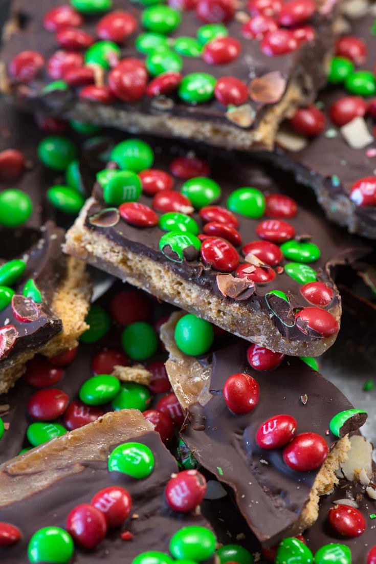 chocolate candy bars with m & m candies all over the top and one half eaten