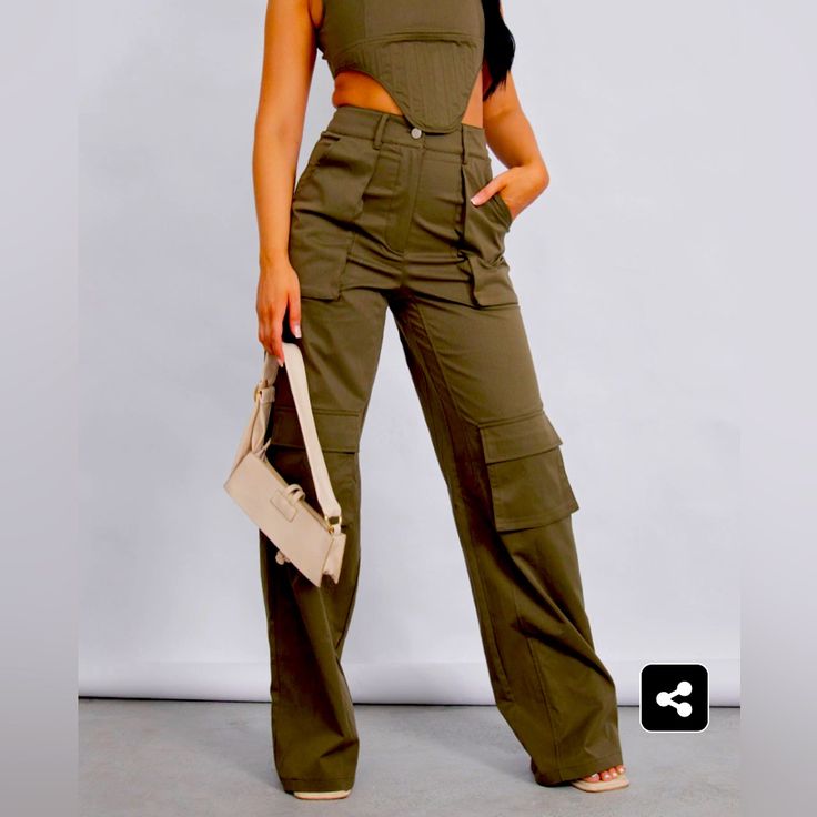 Green Cameo Pants With Pockets Chic High Waist Bottoms With Cargo Pockets, Chic High-waisted Bottoms With Cargo Pockets, Chic Khaki Cargo Pants For Spring, Chic Cargo Pants With Pockets For Day Out, Trendy Cargo Style Bottoms For Workwear, Trendy Cargo Style Wide Leg Workwear Pants, Trendy Cargo Style Workwear Bottoms, Chic Green Pants With Pockets, Chic Green Cargo Pants For Fall