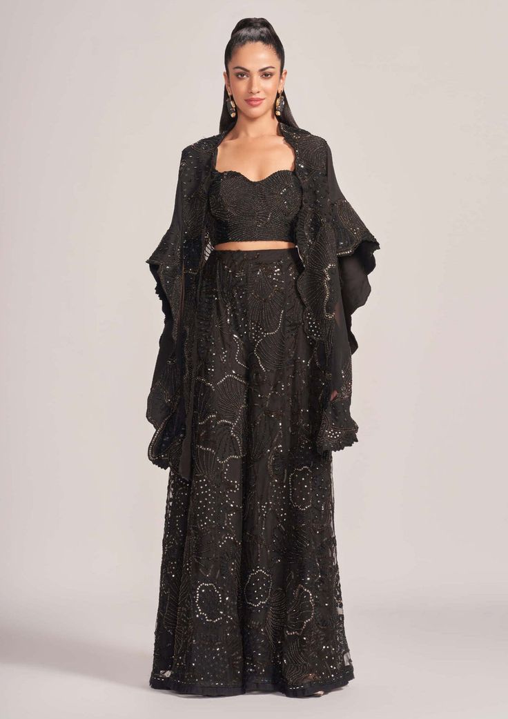 The Zarya black cape, blouse, and palazzo set exudes elegance and sophistication. With a flowing cape, a stylish blouse, and wide-legged palazzo pants, this ensemble is perfect for formal occasions... Palazzo Pants Outfit Indian, Black Palazzo Pants Outfit, Blouse And Palazzo, Cocktail Black Dress, Palazzo Pants Outfit, Cape Blouse, Black Palazzo Pants, Black Cape, Palazzo Set