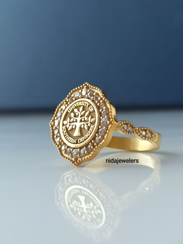 This product is GUARANTEED for life. * College graduation rings for men and women delicately engraved with your school logo or any other initials or image you want. * The ring has solid back. Deep and detailed engraving very delicately handcrafted unisex - looks super cool on both women & men * The ring is 14K Gold * Please contact me for your 14 carat and 18 carat solid gold requests. I can gladly do. * Certified 14k solid gold, hallmarked 14k for solid gold rings. * The ring has solid back Crest Rings Women, Yellow Gold Diamond Filigree Ring For Gift, Diamond Filigree Ring In Yellow Gold As Gift, Heirloom Gold Halo Ring, 22k Gold Heirloom Ring For Anniversary, Diamond Filigree Ring Stamped 14k As Gift, Heirloom 22k Gold Ring For Anniversary, Heirloom 22k Gold Rings For Gift, Heirloom Gold Diamond Halo Ring