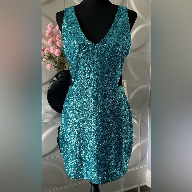 Beautiful, Women's Blue Sequined Party Dress By Bebe In A Size Large Nwt. This Sexy Dress Features A Sleeveless Design With V-Neck And All Over Blue Sequins With Black Mesh Side Vents. Fully Lined. Fabric Is Nylon And Spandex. Measurements When Flat: 19 Inches From Armpit To Armpit. 33 Inches In Length From Top Of Shoulder To Bottom Of Dress. 16 Inches For Waist. 19 Inches For Hips. In Excellent Condition; New With Tag. Tags: Women's Dress, Bebe, Bebe Dress, Sequined Dress, Party Dress, Cocktail Sleeveless Mini Dress For Night Out, Sleeveless Mini Dress For Evening Parties, Party-ready Sleeveless Club Mini Dress, Sleeveless Party-ready Club Dress, Sleeveless Party-ready Mini Dress For Prom, Sleeveless Sequin Dress For Club And Party Season, Sleeveless Sequin Dress For Club Party Season, Sleeveless Sequin Dress For Club Parties, Glamorous Sleeveless Sequin Club Dress