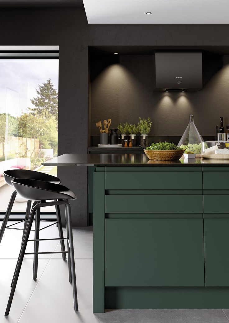 a modern kitchen with green cabinets and stools