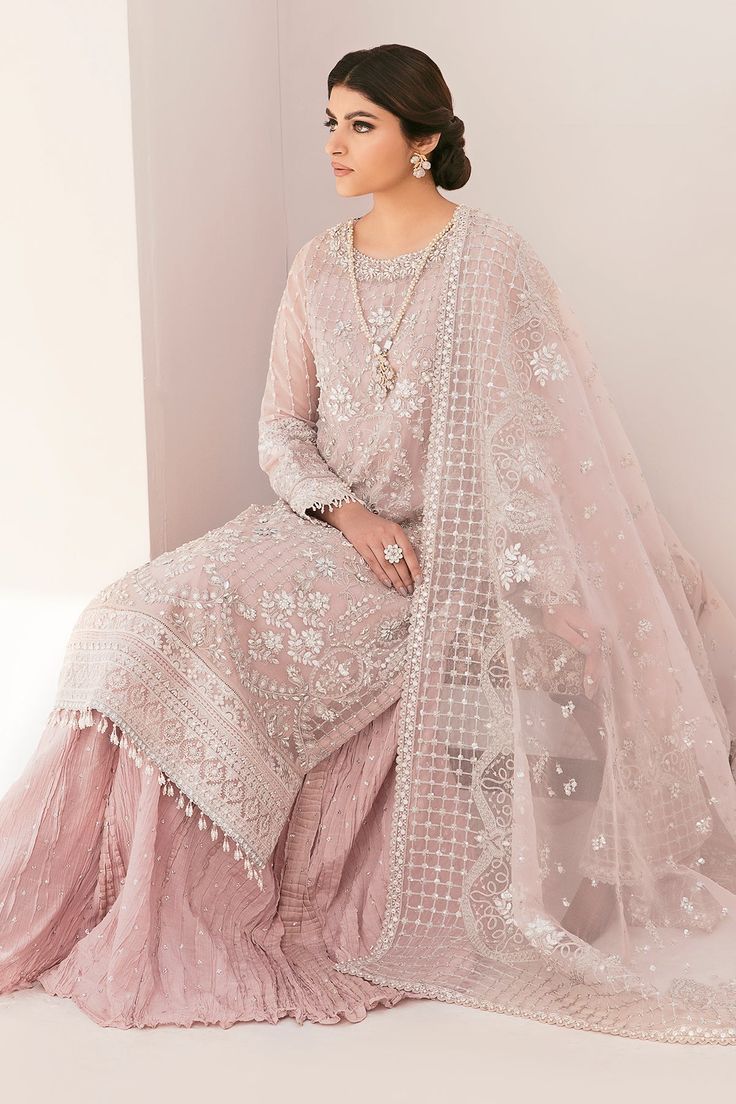 Have a look at Heavily Embellished Baby Pink Pakistani Kameez Salwar Suit Dupatta that gives an alluring look with hand crafted detailing of zari, naqshi, dabka. this is an elegant masterpiece that wins everyone's hearts at the very first glance with its charm. Lavish designs and hand-crafted embellishments make this beautiful Sharara Dress your foremost priority for the big day. Embroidered Chiffon Kameez: The beautiful kameez salwar in an alluring pink color is adorned with shimmering embellis Sets With Resham Embroidery For Wedding And Eid, Resham Embroidered Sets For Wedding And Eid, Eid Wedding Sets With Resham Embroidery, Wedding Sets With Dabka Work For Eid, Embellished Sets For Wedding And Eid, Embellished Unstitched Anarkali Suit, Embellished Semi-stitched Dupatta For Eid, Eid Embellished Organza Palazzo Set, Organza Sets With Mirror Work For Eid