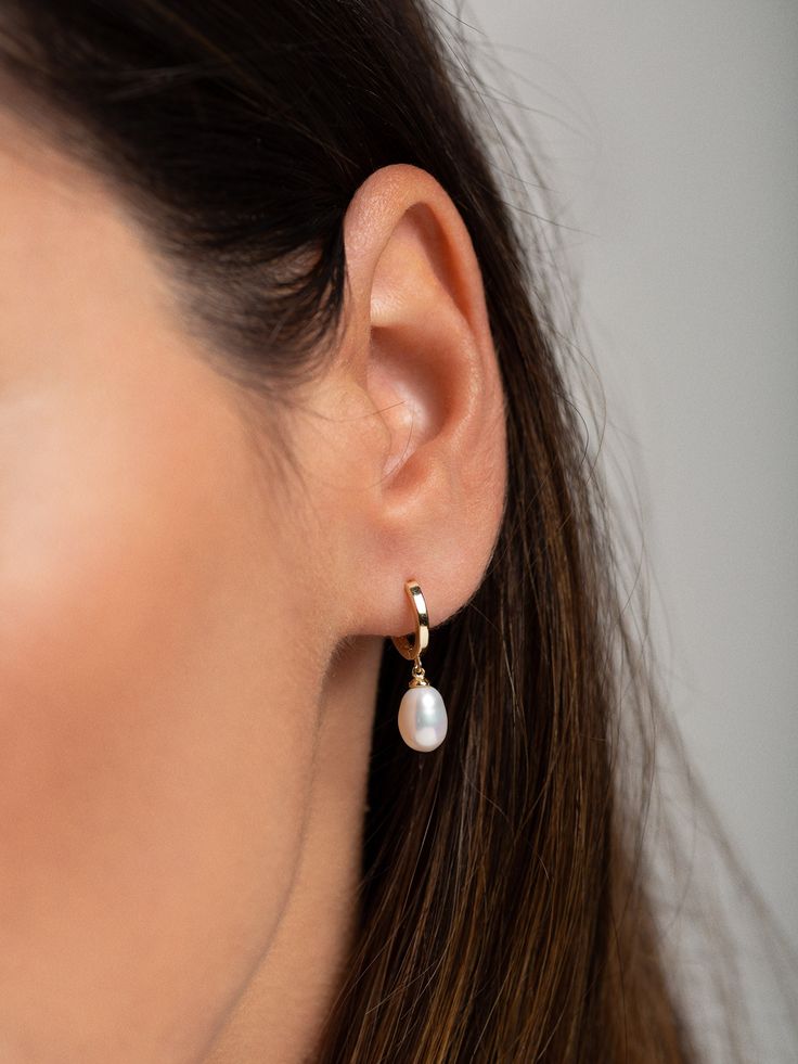 "Classic, clean and elegant, this beautifully minimal pair of pearl hoops will easily become an everyday staple. * D E T A I L S * ∙ Sold as a PAIR ∙ Material: .925 Sterling Silver or 18K Gold Plated over .925 Sterling Silver ∙ Stone: Freshwater Pearl ∙ Dimensions: Outer diameter: 12mm // Pearl: Approx: 6mm (w) x 9mm (h) ∙ Hypoallergenic & nickel-free * P A C K A G I N G * ∙ All jewelry is sent out beautifully packaged in our signature box & ready for gifting. ∙ In order to reduce waste, we ofte Cheap Everyday Pearl Earrings For Pierced Ears, Luxury Pearl Drop Huggie Earrings, Luxury White Huggie Earrings With Pearl Drop, Luxury Huggie Pearl Earrings For Formal Occasions, Cheap Minimalist Pearl Earrings, Luxury Minimalist Pearl White Pearl Earrings, Luxury Everyday Pearl Earrings, Luxury Small Hoop Pearl Earrings For Everyday, Luxury Small Hoop Pearl Earrings For Wedding