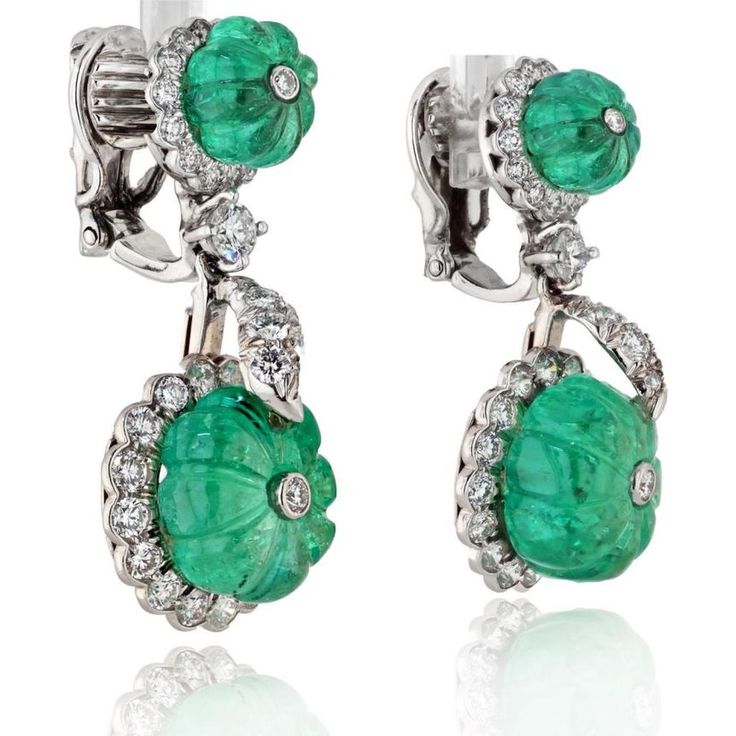 Celebrate the intersection of creativity and class in these exquisite David Webb Platinum Carved Green Emerald And Diamond Drop Earrings. Adorn your ears with the allure of nature's green beauty, embodied in the captivating carved green emeralds that dangle gracefully, accentuated by the brilliance of round-cut diamonds. Each earring is a masterpiece, meticulously crafted in platinum, weighing a luxurious 22.0 grams, ensuring durability and timeless elegance. Designed by the renowned David Webb, these earrings are a testament to his artistic vision and exceptional craftsmanship, making them a coveted addition to any jewelry collection.Indulge in the allure of luxurious green hues and sparkling diamonds, perfect for special occasions or to elevate your everyday style with a touch of sophist Luxury Green Clip-on Earrings For Formal Occasions, Luxury Green Clip-on Jewelry, Luxury Green Clip-on Earrings, David Webb, Diamond Birthstone, Green Hues, Diamond Drop Earrings, Platinum Metal, Diamond Drops