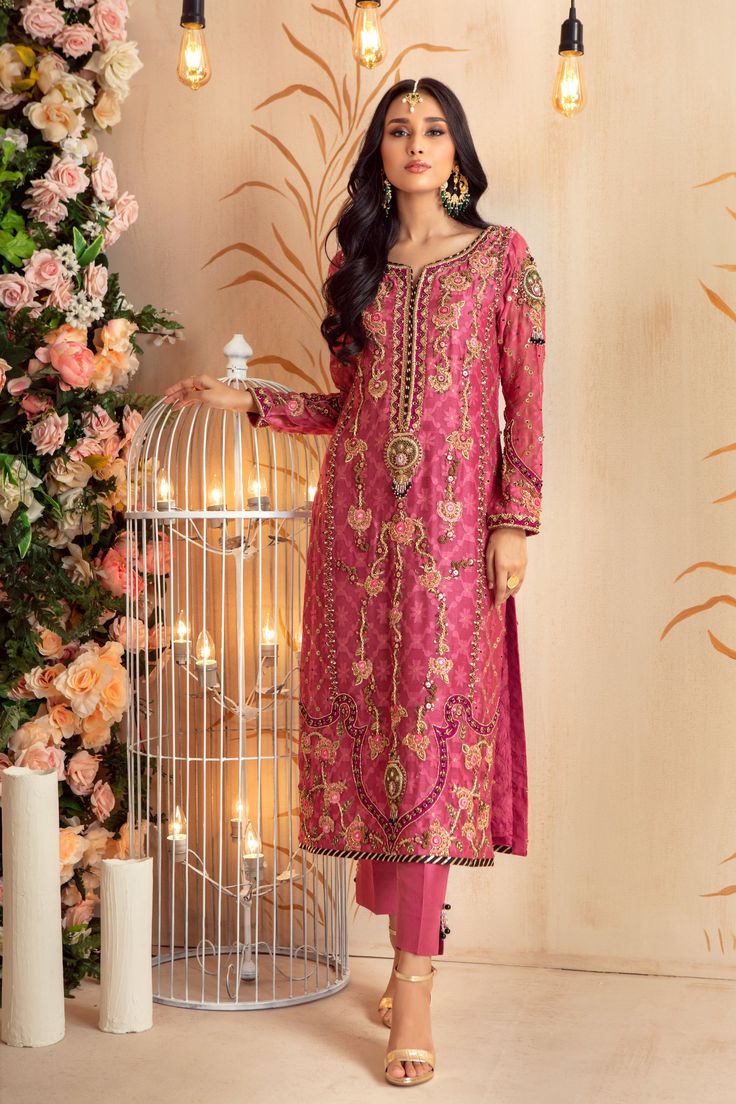 Over a canvas of Jacquard silk net in stunning raspberry Hue, featuring a beautiful medley of monotones in floral embroidery further enhanced with antique gold dabka, kora, sequins, crystals, beads, gota & mirror work. This stunning outfit is paired with chiffon gota embellished color blocked dupatta and raw silk pant, perfect for any celebratory occasion. Shirt Fabric: Pure Jacquard Silk Net Shirt Length: 45” Pant Fabric: Pure Raw Silk Dupatta Fabric: Pure Chiffon Shirt & Pant Color: Raspberry Brocade Salwar Kameez With Dabka Work For Wedding, Elegant Dabka Embroidered Fabric For Festive Occasions, Semi-stitched Brocade Set With Dabka Work, Festive Anarkali Embroidered Fabric With Dabka, Unstitched Dabka Embroidered Chanderi Fabric, Pink Lawn Suit With Mirror Work For Festivals, Elegant Pink Lawn Suit With Zari Work, Wedding Embroidered Chanderi Fabric With Dabka, Semi-stitched Anarkali Embroidered Fabric With Dabka