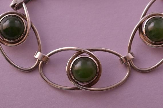 A retro silver bracelet set with genuine semi precious stones.Condition: Excellent Elegant Cabochon Bracelet Jewelry, Modernist Round Cabochon Jewelry, Art Deco Sterling Silver Cabochon Jewelry, Art Deco Polished Bracelets For Gift, Modernist Jewelry Bangle With Polished Finish, Silver Metal Bracelet With Stone Setting, Art Deco Polished Finish Bracelets As Gift, Metal Bracelets With Stone Setting, Modern Bracelets With Natural Stones