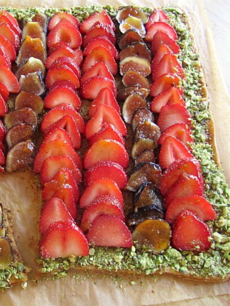 there is a cake with strawberries on it and other toppings around the edges