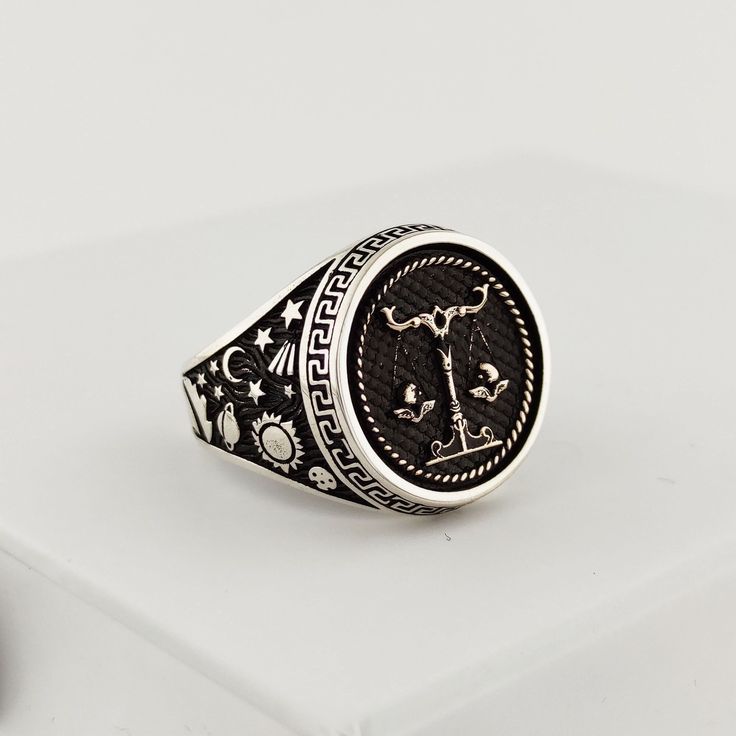 The ring is made of 925 sterling silver with fine workmanship. Planets, stars and comets are embroidered on the sides of the ring. PRODUCT FEATURES * Mineral Production: 925 Sterling Silver, Bronze * Weight: 13.5 grams * Ring Diameter: 18 mm Libra on the ring, sun, moon and star embroideries are made on the sides. The ring can be changed upon request. * Ready to Ship in 1-3 Business Days * Shipped within 1-3 business days worldwide with free express shipping. * The product will be sent to you wi Celestial Silver Rings With Polished Finish, Symbolic Zodiac Sign Rings, Celestial Silver Signet Ring, Celestial Engraved White Gold Rings, Celestial Silver Rings Stamped 925, Silver Celestial Signet Ring As Gift, Celestial Silver Signet Ring For Gift, Silver Celestial Style Signet Ring For Gift, Silver Zodiac Sign Ring