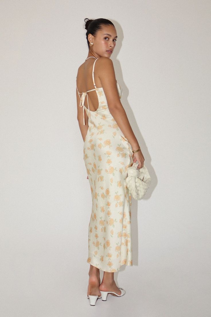 Indulge in luxury with the Caden Bias Cut Maxi Dress this season! This elegant dress looks and feels like a work of art; it features a unique bias cut that enhances your silhouette, while the floral satin and creamy hue make it a decadent choice for any occasion. Pair with dainty heels and a clutch for an easy outfit that's anything but basic. Also available - the Caden Maxi Skirt, sold separately. FIT: Runs true to size. MODEL: Model is 5’7” / wearing a small. MATERIAL: Self: 100% Polyester; Li Spring Silk Midi Dress With Bias Cut, Chic Silk Slip Dress For Garden Party, Spring Fitted Silk Dress With Bias Cut, Cream Satin Spring Dress, Spring Fitted Bias Cut Silk Dress, Fitted Silk Dress With Bias Cut For Spring, Spring Cream Satin Midi Dress, Cream Satin Maxi Dress For Summer, Cream Satin Midi Dress For Spring