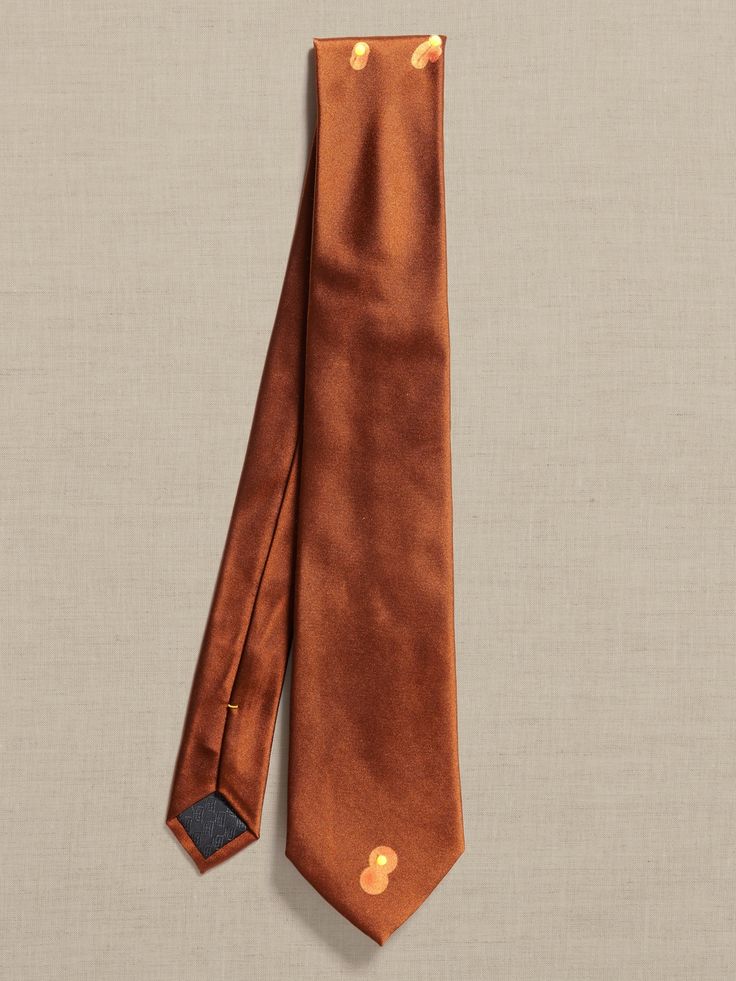 Spun luxury, this incredibly dapper tie is crafted from silk twill for a sophisticated feel on a unique silhouette.  Hand-pressed and shaped for a clean finish.  Measures 3" at widest point.  Length: 58" (147cm) Solid Dapper Ties For Formal Occasions, Dapper Solid Color Ties For Business, Classic Brown Neckwear With Ties, Dapper Neckwear With Ties For Business, Dapper Brown Tie For Business, Timeless Suit And Tie Accessories For Business, Brown Semi-formal Standard Tie, Timeless Business Suit And Standard Tie Accessories, Classic Formal Necktie