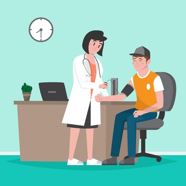 a doctor is talking to a patient at his desk in front of a laptop computer