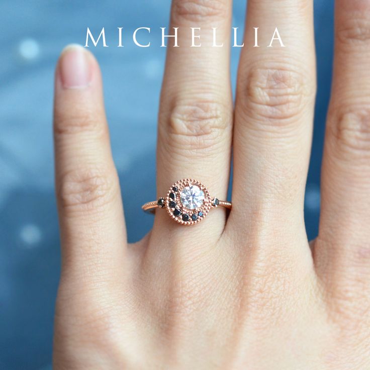 a woman's hand with a diamond ring on top of her finger and the words michellia above it