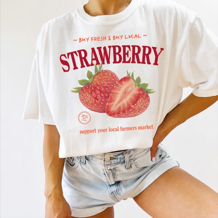 Made-to-order "Farmers Market Strawberry" tee shirt! Printed on a Comfort Colors garment-dyed t-shirt. If you enjoy this product, I would love you to leave a review! ✿  HOW TO ORDER ✿ 1. Choose the shirt color from the 1st dropdown. 2. Choose the shirt size from the 2nd dropdown. 3. Add each item to the cart.  ✿  Sizing & Fabric ✿ These shirts are unisex, meaning they tend to run wider/longer than women's styles might. The soft-washed, garment-dyed fabric brings extra coziness to your wardrobe, Organic Cotton T-shirt For Spring, Retro Cotton Top With Strawberry Print, Organic Graphic Print T-shirt For Spring, Organic White Graphic Print Tops, Organic White T-shirt For Summer, Cute Organic Cotton T-shirt For Spring, Organic Crew Neck Tops For Spring, Organic Relaxed Fit T-shirt For Spring, Relaxed Fit Fruit Print T-shirt For Spring