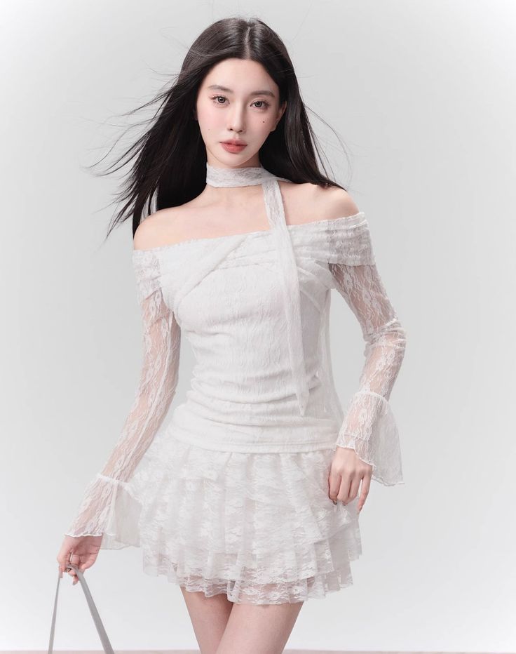 This elegant white lace one-shoulder crop top and skirt set features delicate lace detailing and a flattering one-shoulder design. Perfect for any occasion, this set exudes sophisticated charm and showcases your unique sense of style. Elevate your wardrobe with this must-have ensemble. ■ Model Info Height: 169 cm Weight: 47 kg Wearing Size: M Fitted Off-shoulder Lace Dress, Chic Off-shoulder Lace Dress With Lace Trim, White Off-shoulder Lace Dress, Spring Party Off-shoulder Lace Top, Chic Off-shoulder Lace Top, White Off-shoulder Lace Dress For Party, Fitted Off-shoulder Lace Top For Party, Off-shoulder Lace Tops For Party, Tiered Mini Skirt