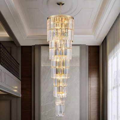 a chandelier hanging from the ceiling in a living room with marble floors and walls