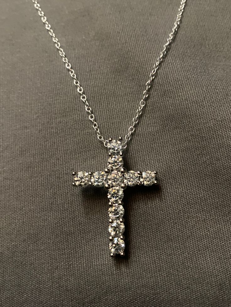 "A 3.20 total carat moissanite diamond with a cross design made on sterling silver, the diamond is lab created at a VVS1. comes with a necklace made of sterling silver at 18\"long" Sterling Silver Diamond Cut Cross Necklace, Sterling Silver Diamond Cut Cross Pendant Necklace, Sterling Silver Cross Necklace With Diamond Cut, Sterling Silver Cross Diamond Necklace With Diamond Cut, Sterling Silver Cross Diamond Necklace, Sterling Silver Diamond Cut Pendant Cross Necklace, Sterling Silver Cross Pendant Necklace, Anniversary Silver Cross Necklace With Brilliant Cut, Silver Diamond-cut Cross Necklace For Anniversary