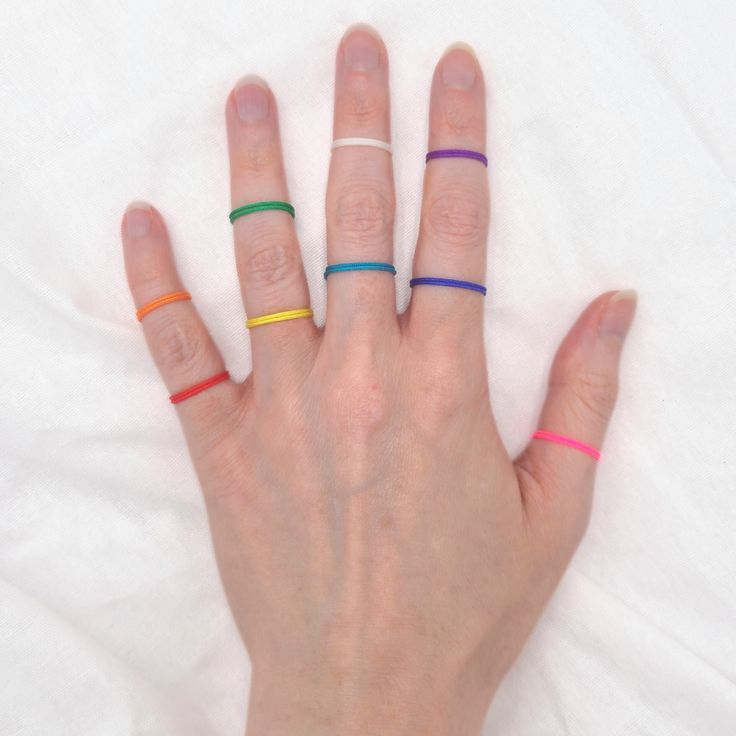 These simple string rings are the perfect accessory for everday wear! With 27 bold and beautiful colors to choose from, there is something for everyone to love! Collect all of your favorite colors to wear together, stack, or match every outfit.  They can be worn as traditional rings, or you can wow your friends at the beach this summer by sporting them on your toes! Add a pop of color to your feet and hop in the pool with these non tarnishing, comfortable, water resistant bands and you will neve Adjustable Midi Rings For Summer, Minimalist Midi Rings For Summer Gift, Trendy Adjustable Midi Rings For Summer, Minimalist Midi Rings As Summer Gift, Rainbow Adjustable Minimalist Jewelry, Minimalist Adjustable Rainbow Jewelry, Minimalist Adjustable Pink Stackable Rings, Colors To Wear Together, String Rings