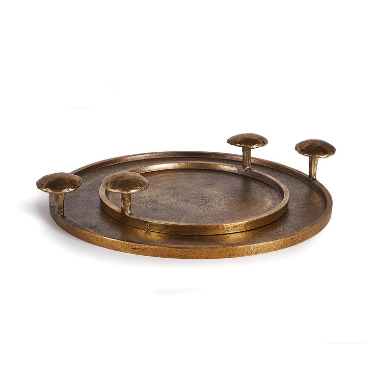 an antique brass tray with three candles on it and four knobs in the middle