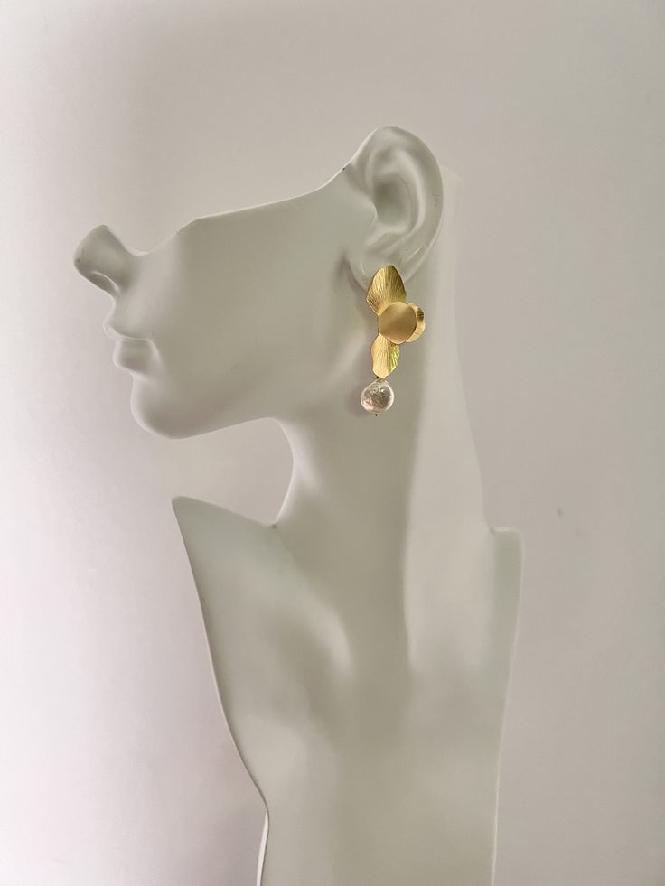 Gold Floral Coin Pearl Earrings Elegant matte gold orchid flower earrings with coin pearl dangle.  One petal is bent to look unique. Very lightweight. Dangle length is 50mm from ear post. CUSTOM REQUESTS ARE ALWAYS WELCOME! ~ Feel free to message me if you have any questions or special requests ... I will do my best to accommodate. ~ If the size you are wanting is not shown in the menu, contact me before ordering as there may be an additional charge for extra material ~ custom lengths for most n Gold Wrap Drop Earrings For Wedding, Gold Drop Earrings For Wedding, Gold-plated Dangle Flower Earrings For Pierced Ears, Delicate Gold Pearl Single Earring, Gold Plated Flower Dangle Earrings, Gold Plated Dangle Flower Earrings, Elegant Single Teardrop Flower Earring, Gold Metal Flower Earrings For Wedding, Gold Drop Flower Earrings For Pierced Ears