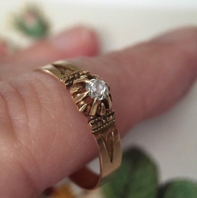 "A simply stunning engagement ring or love token! Not too much bling but full of sentiment and romance, this 14K gold Victorian ring is a charmer. The ring band is 14K gold (tested) and is approximately 1/8\" wide. The shoulders of the setting are carefully engraved. I love the unusual mounting of the diamond; the gem is cradled by multiple prongs which create a star-like effect. The small but sparkly diamond is 3 mm in diameter or approximately .11 carats. The ring is a US size 6.75. This antiq Heirloom Yellow Gold Engraved Promise Ring, Vintage 14k Gold Promise Jewelry, Heirloom Gold Engraved Ring For Promise, Heirloom Gold Engraved Promise Ring, Heirloom Engraved Promise Ring, Antique 14k Stamped Birthstone Wedding Ring, Antique Engraved Promise Ring Jewelry, 14k Gold Solitaire Engraved Ring For Anniversary, Heirloom 14k Gold Promise Diamond Ring