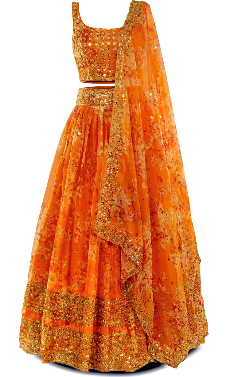 Orange you gonna be cute in this? Yes, you sure will! This 3-piece orange lehenga is your ticket to citrus chic. The lehenga is adorned with stunning gold embroidery and sequins all throughout. Get ready to peel off ordinary and stand out at your next Indian event! This outfit is perfect for any Indian festivity, especially the Haldi ceremony. Orange Georgette Sharara For Navratri, Orange Georgette Sets For Festivals, Orange Georgette Sharara With Traditional Drape, Designer Orange Sharara With Zari Work, Festive Designer Orange Sharara, Festive Orange Designer Sharara, Designer Orange Sharara With Sheer Dupatta, Festive Orange Sharara With Sheer Dupatta, Orange Georgette Sharara For Festivals