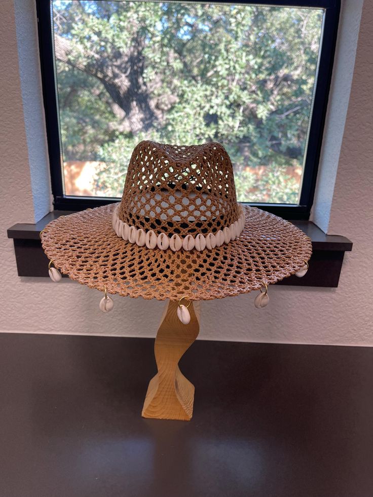 Wide brim straw cowrie seashell western summer cowgirl/cowboy hat. Please note each item is handmade so may have minor imperfections, but is constructed to the best of my ability. Thank you for understanding! Handmade Country Straw Hat, Handmade Country Style Straw Hat, Handmade Straw Hat For Spring Rodeo, Handmade Western Straw Hat, Handmade Country Style Sun Hat For Summer, Handmade Straw Hat For Rodeo In Spring, Handmade Summer Hats For Country Events, Handmade Western Style Beach Hat, Handmade Straw Western Hat Bands