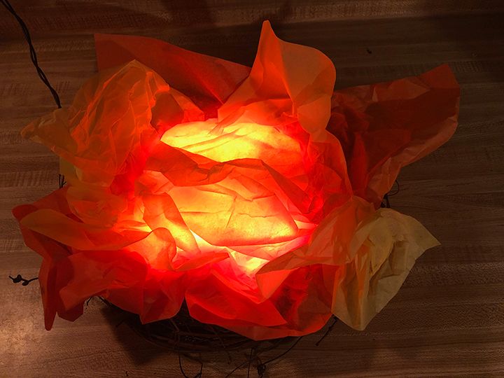 a red light that is sitting on top of a wooden table next to a basket