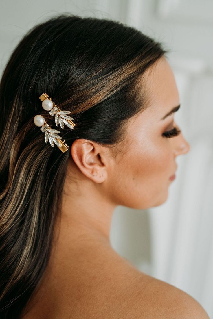 Emery Hair Clip Set  For the bride looking to add the perfect vintage piece to her wedding day, our Emery Hair Clip Set styles elegantly into any hairstyle. Adorned with art deco inspired crystals and stones, this mini clip set is sure to make a statement. Available in stone combos: Gold Stones and Pearl Clear Stones and Pearl White Stones and Opal Dimensions: Each clip is 2" long and 0.75" wide at the widest point. Sold as a pair. Each order is thoughtfully gift wrapped and shipped in a gold em Art Deco Bridal Hair, Gold Headpiece Wedding, Wedding Hair Pin, Crystal Hair Clip, Headpiece Wedding Hair, Art Deco Hair, Pearl Bridal Headband, Wedding Hair Head Piece, Wedding Barrettes