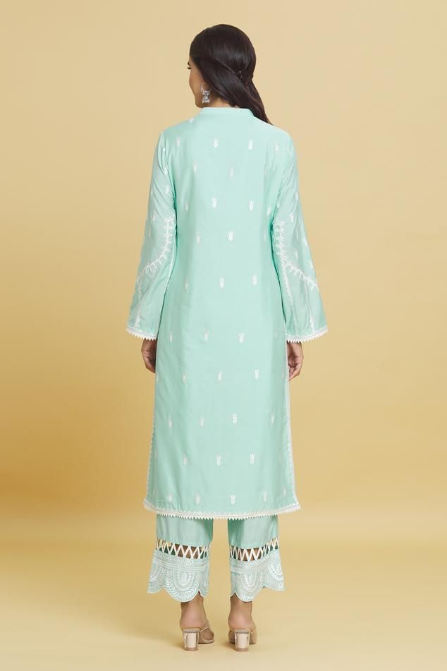 Aqua kurta with all over thread embroidered paisley and floral motifs. Comes with pant and dupatta.
Components: 3
Pattern: Embroidered
Type Of Work: Thread
Neckline: Mandarin Collar
Sleeve Type: Full
Fabric: Cotton Silk
Color: Blue
Other Details: 
Attached lining
Straight silhouette
Lace borders
Length:
Kurta: 44 inches
Pant: 40 inches
Weight: 1 kg
Occasion: Sangeet - Aza Fashions Unstitched Palazzo Set With Embroidered Border For Eid, Bollywood Style Straight Kurta Palazzo Set With Chikankari Embroidery, Bollywood Style Palazzo Set With Chikankari Embroidery, Bollywood Style Pista Green Palazzo Set With Embroidered Border, Pista Green Cambric Kurta With Resham Embroidery, Diwali Palazzo Set With Resham Embroidery In Cambric, Eid Lawn Suit With Embroidered Border And Straight Kurta, Lawn Suit With Embroidered Border For Eid, Designer Cotton Palazzo Set With Embroidered Border