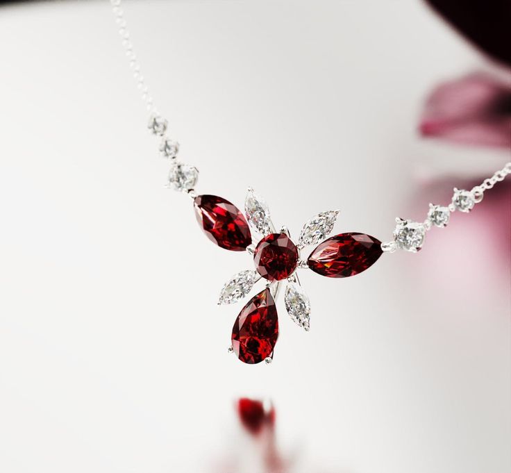 Introducing Crimson Bloom: Crafted as a romantic high-end floral necklace to complement any of our other pieces as a set or to shine brightly on it's own. This classical necklace is perfect for any occassion. As a gift for her, a supplement to an engagement ring or a gift for yourself - because you deserve it - it is guaranteed to impress. A bright and shiny string of simulated diamonds and garnets make this necklace stand out and is sure to bring lots of compliments. Each stone shines brightly Elegant Flower-shaped Jewelry For Mom, Elegant Flower Pendant Jewelry For Mom, Elegant Flower Pendant Jewelry Gift For Mom, Elegant Flower Pendant Necklaces For Valentine's Day, Elegant Flower Pendant Necklace For Valentine's Day, Elegant Flower Shaped Necklace For Mom, Elegant Sterling Silver Necklace For Mom, Elegant Sterling Silver Necklace Gift For Mom, Elegant Jewelry For Mom As Valentine's Day Gift