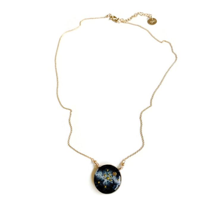 A beautiful, handmade reminder of our place in the universe and connection to each other. This Solar System Necklace has golden glass microbeads carefully hand placed to create our sun and planets on a backdrop of the shimmering milky way galaxy made of mica. The scene floats in a sparkling inky resin and is covered with a clear dome, adding dimensions and depth to this celestial scene. Stamped with the word STARDUST, the bezel is hand cast from your choice of sterling silver or bronze and hangs Celestial Satellite Chain Jewelry As Gift, Celestial Style Jewelry With Satellite Chain As Gift, Adjustable Necklace With Satellite Chain And Round Shape, Round Satellite Chain Jewelry As Gift, Celestial Jewelry With Satellite Chain As A Gift, Celestial Style Round Necklace With Adjustable Chain, Cosmic Style Handmade Jewelry As A Gift, Keepsake Round Pendant With Natural Inclusions, Celestial Jewelry With Satellite Chain For Gifts