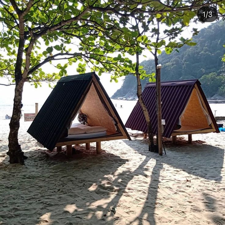 two tents are set up on the beach