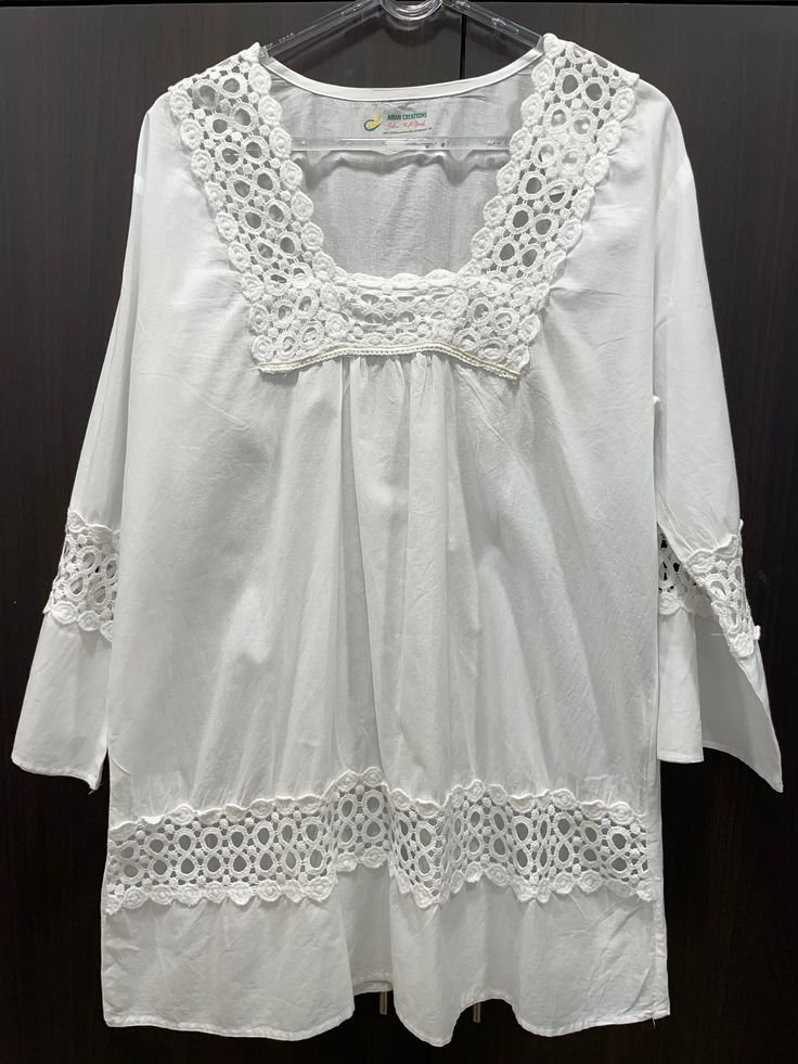 Introducing the perfect attire for you or a gift for your sister, daughter or your mom, a stunning pure cotton tunic that combines style, comfort, and exquisite design. Crafted with utmost care and attention to detail, this tunic showcases the timeless artistry of chikankari embroidery, adding a touch of elegance to its overall appeal. Made from high-quality pure cotton fabric, this tunic ensures exceptional comfort, allowing  a relaxed and effortless style. The soft and breathable material gent Luxury Chikankari Embroidered Tunic Dress, Embroidered Cotton Lace Top For Summer, Summer Embroidered Cotton Lace Top, Spring Embroidered Cotton Lace Top, White Cotton Lace Top For Summer, White Tunic With Chikankari Embroidery, White Chikankari Embroidered Tunic, Summer Cotton Lace Top For Daywear, Cotton Lace Top For Summer Daywear