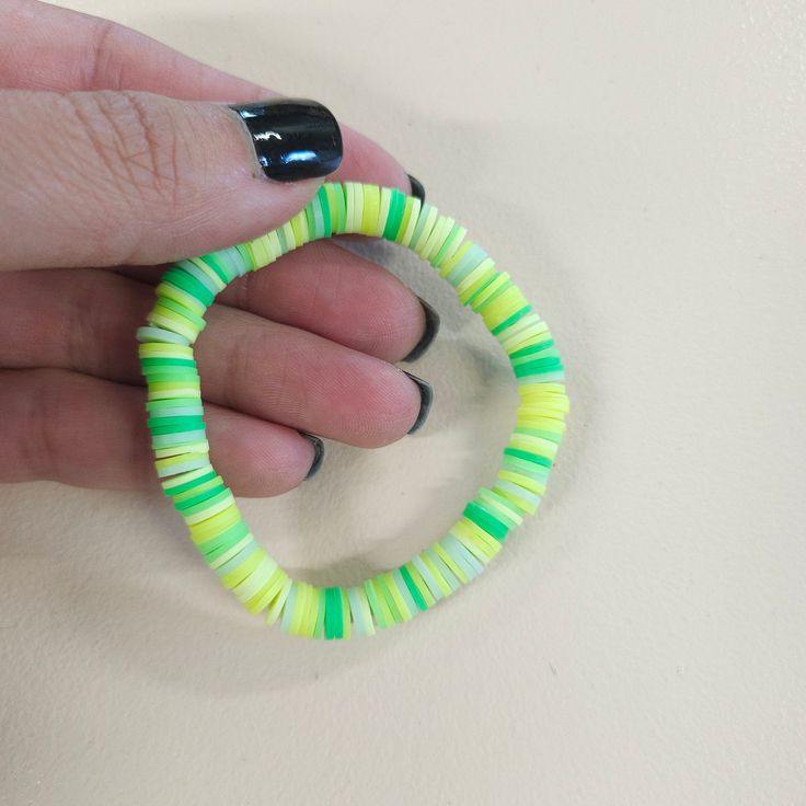 Lime green bracelet. Neon Green Clay Bracelet, Summer Green Hand-strung Beaded Bracelets, Green Hand-strung Braided Bracelet With Round Beads, Vibrant Green Adjustable Bracelets, Hand-strung Green Round Beads, Stretchy Bracelets, Yarn Needle, Clay Beads, Knitting Needles