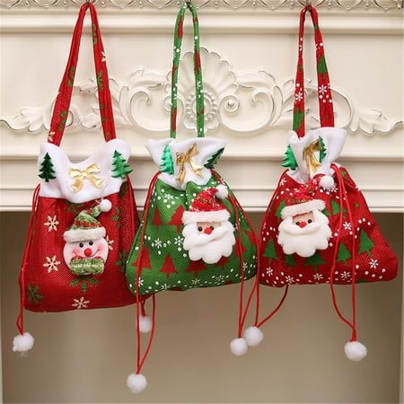 three santa claus bags hanging from a mantel