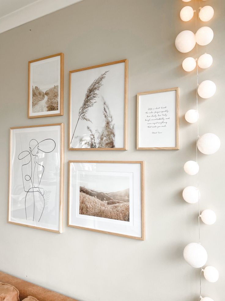 a living room with pictures and lights hanging on the wall