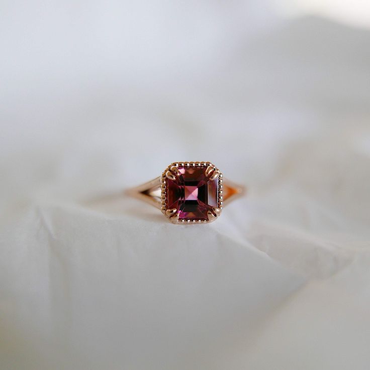 Say hello to the beautiful Square Raspberry Tourmaline Ring! This beautiful ring is an instant classic. A perfect engagement ring for the unconventional bride or even a right hand ring. If you love pinks and reds, this is the statement ring for you! Details: 14k rose gold OOAK (one of a kind) Hand engraved setting Size 6 *Can be resized**Please Write Desired Size in Note Section Upon Checkout** Raspberry Tourmaline measures about 6.3mm Free Shipping on Domestic Orders Materials: tourmaline, 14k Vintage Baguette Ring, Beautiful Gold Engagement Rings, Red And Gold Engagement Ring, Ruby Engagement Ring Vintage, Unconventional Bride, Statement Engagement Ring, Tourmaline Engagement Ring, Gemstone Wedding Rings, Right Hand Ring