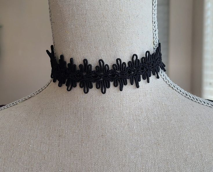 "This gorgeous black choker has a knotted design. The choker is about 13\" long with a 2\" extender chain that has a faceted black glass bead. Has a lobster clasp. It's the perfect fashion accessory, modern or historical. Comes in a lovely box with ribbon. In the Eighteenth and Nineteenth centuries, chokers were very fashionable. Some were made of pearls, lace or ribbon and can be seen in many classic portraits. I think they're a very elegant accessory even today." Adjustable Black Choker For Party, Black Adjustable Choker For Party, Adjustable Black Gothic Choker, Adjustable Black Band Choker, Adjustable Black Ribbon Party Choker, Adjustable Black Choker, Elegant Black Choker With Adjustable Length, Adjustable Black Necklace With Black Ribbon, Adjustable Black Ribbon Choker Jewelry