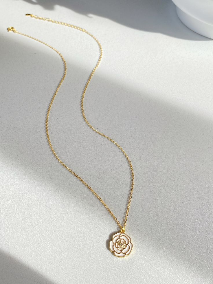 Adorn yourself with the beauty of nature with our Camellia pendant necklace! This necklace features a stunning camellia flower that represents love, admiration and gratitude. The elegant design is completed with sterling silver plated with gold cable chain, making it perfect for everyday wear or special occasions.  It's so beautiful either have it alone or layered with other necklace, have it with dress or sweater. Pendant size is 1.2cm Necklace length is 40+5.5cm As it's a handmade item please allow 2-3mm difference. Please keep them away from chemicals such as perfume, hairspray ect. Better remove before shower and swim.   The product is made by care and love 💕 Rose Gold Flower Pendant Clavicle Necklace, Rose Gold Clavicle Chain Necklace With Flower Pendant, Dainty Rose-colored Flower-shaped Jewelry, Rose Gold Flower Pendant Necklace With Delicate Chain, Delicate Rose Flower Shaped Jewelry, Elegant Birth Flower Necklace As A Gift For Mom, Feminine Necklace With Flower Pendant For Her, Feminine Necklace With Flower Pendant As Gift For Her, Elegant Rose Necklaces With Clavicle Chain