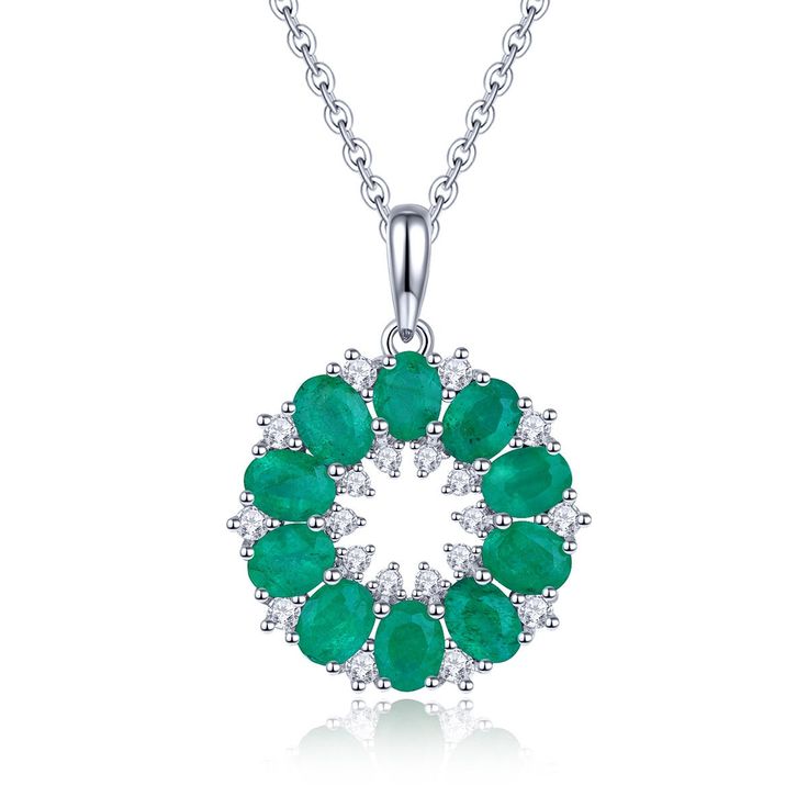 Introducing our Round Emerald Necklace Silver, a stunning piece of jewelry perfect for gifting on special occasions like birthdays, anniversaries, or as a thoughtful present for your wife. This exquisite necklace features a captivating circular pendant design. At its center lies a circle of tiny white zircon stones, delicately set in prong settings to enhance their brilliance. Surrounding this inner circle are ten natural Zambian emerald gemstones, each showcasing their vibrant green hue in a 4 by 3 prong setting formation. Completing the design is another circle white zircon stones, adding a touch of elegance and sparkle to the pendant. The combination of the lush green emeralds and the shimmering white zircon accents creates a mesmerizing and eye-catching look. Crafted with high-quality Luxury Green Round Pendant Jewelry, Exquisite Diamond Necklace With Emerald, Exquisite Round Emerald Diamond Necklace, Green Round Gemstone Diamond Necklace, Dazzling Emerald Necklace For Anniversary, Round Gemstone Necklaces With Cubic Zirconia, Round Cubic Zirconia Gemstone Necklace, Crystal Gemstone Round Pendant Jewelry, Diamond White Gemstone Round Necklace