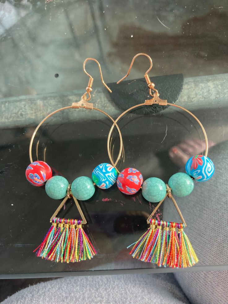 These handmade, homemade beach beauties are perfect for your next tropical vacation. The colorful tassels and beads evoke a sense of relaxation and fun. Hurry and pick these lightweight babies up! Blue Bohemian Tassel Earrings For Summer, Bohemian Blue Tassel Earrings For Summer, Bohemian Turquoise Tassel Earrings With Colorful Beads, Bohemian Tassel Earrings For Summer Vacation, Festival Turquoise Tassel Earrings With Colorful Beads, Turquoise Tassel Earrings With Colorful Beads For Festival, Handmade Turquoise Tassel Earrings For Festival, Multicolor Beaded Tassel Earrings For Beach, Turquoise Handmade Tassel Earrings For Festivals