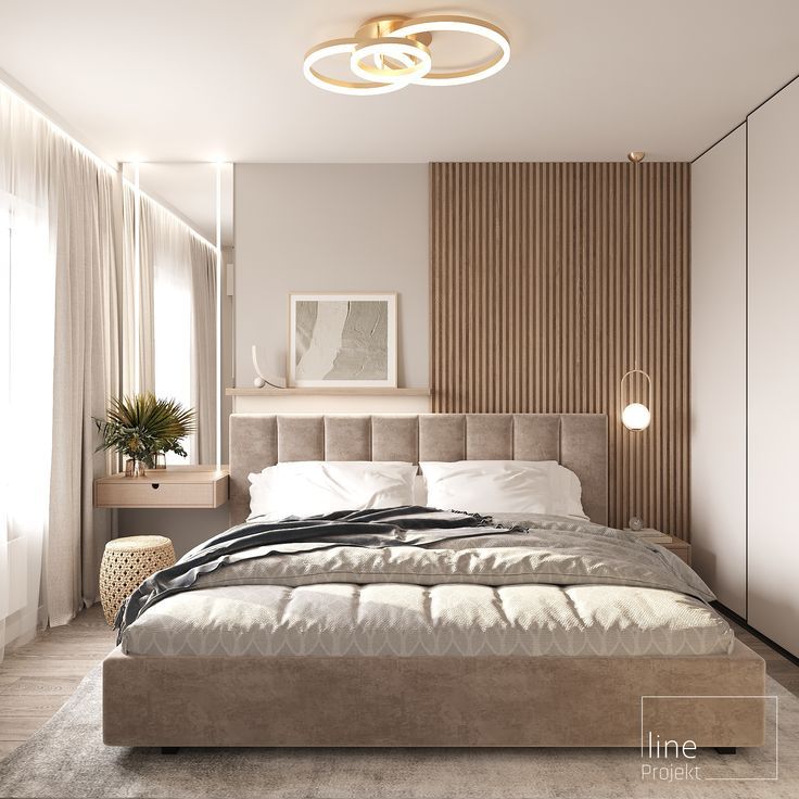 a large bed sitting in the middle of a bedroom next to a wall mounted light